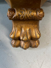 Load image into Gallery viewer, 20th-century Empire-style Hollywood Regency coffee table featuring a round white marble top with elegant gray veining, supported by a gilded wood base with bold lion paw feet and neoclassical design elements