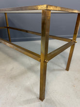 Load image into Gallery viewer, 1970s brass console table featuring a sleek white Vitrolite glass top and a minimalist rectangular brass frame with clean lines and mid-century modern influence