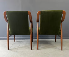 Load image into Gallery viewer, Pair of Danish lounge chairs in the style of Peter Hvidt, featuring sculptural walnut frames and green velvet upholstered seats and backs