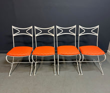 Load image into Gallery viewer, 1940s French mid-century modern outdoor dining set featuring six white wrought iron chairs with orange diamond-patterned cushions and a matching table with decorative curved frames
