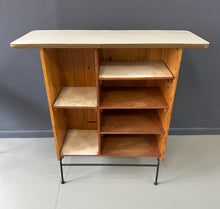 Load image into Gallery viewer, Mid-Century Modern dry bar console with matching stool by Arthur Umanoff, 1950s, featuring slatted wood panels, iron legs, and a curved wooden seat and backrest with minimalist black metal framing