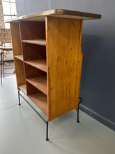 Load image into Gallery viewer, Mid-Century Modern dry bar console with matching stool by Arthur Umanoff, 1950s, featuring slatted wood panels, iron legs, and a curved wooden seat and backrest with minimalist black metal framing