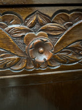 Load image into Gallery viewer, 1920s English Art Nouveau sideboard in oak with ornate floral and vine hand-carving, three-door storage, and bun feet