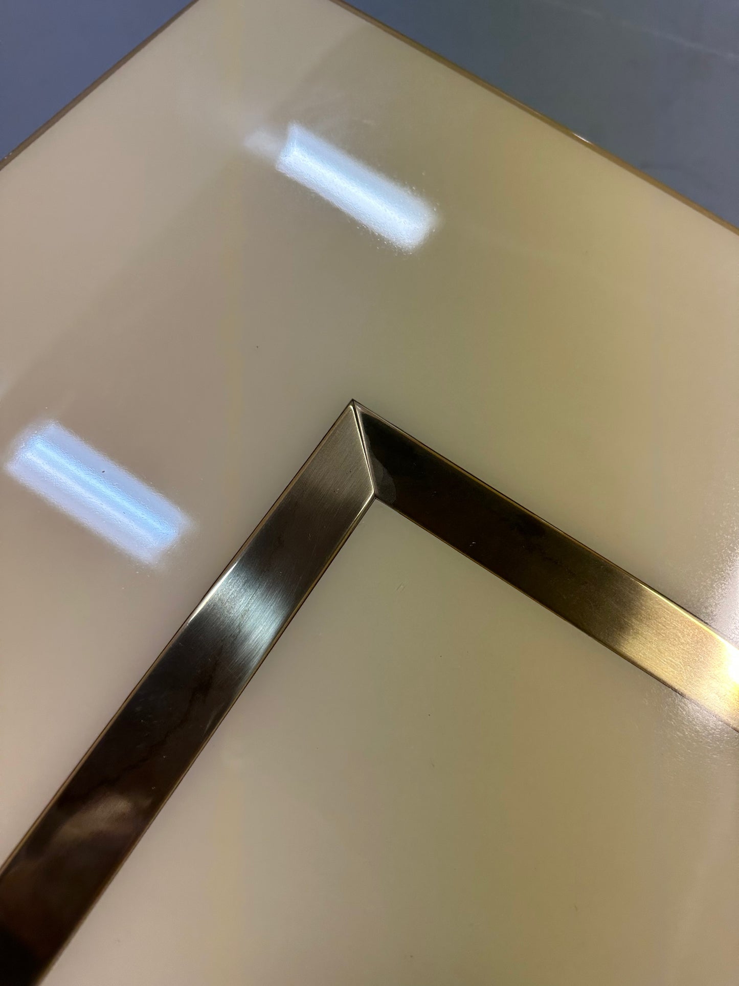 1970s Acrylic Stepped Cream Colored Coffee Table with Brass Ribbon Inlay