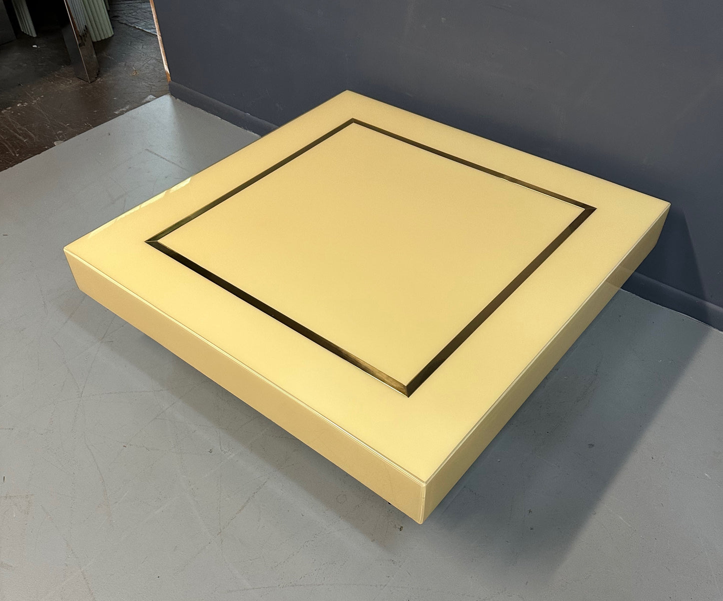 1970s Acrylic Stepped Cream Colored Coffee Table with Brass Ribbon Inlay