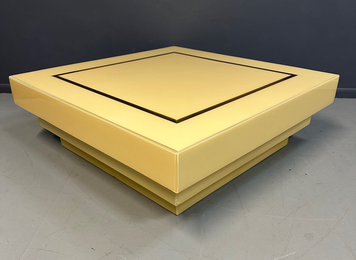 1970s Acrylic Stepped Cream Colored Coffee Table with Brass Ribbon Inlay