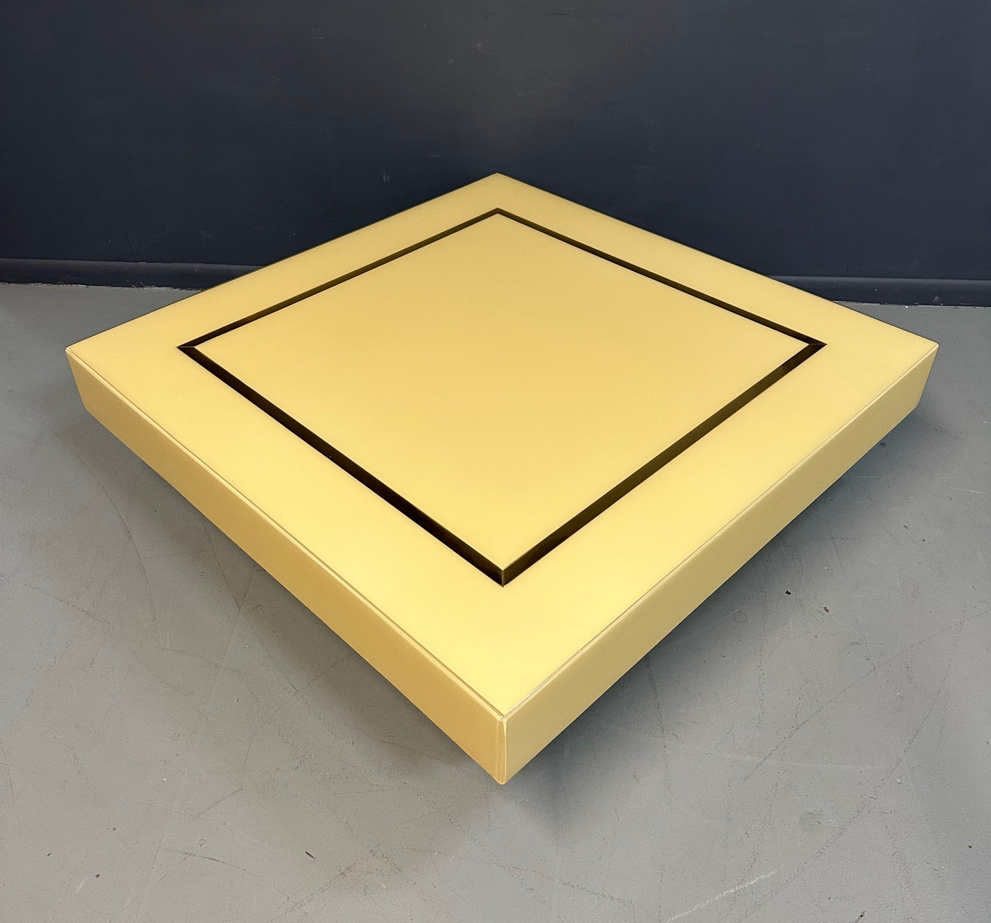 1970s Acrylic Stepped Cream Colored Coffee Table with Brass Ribbon Inlay