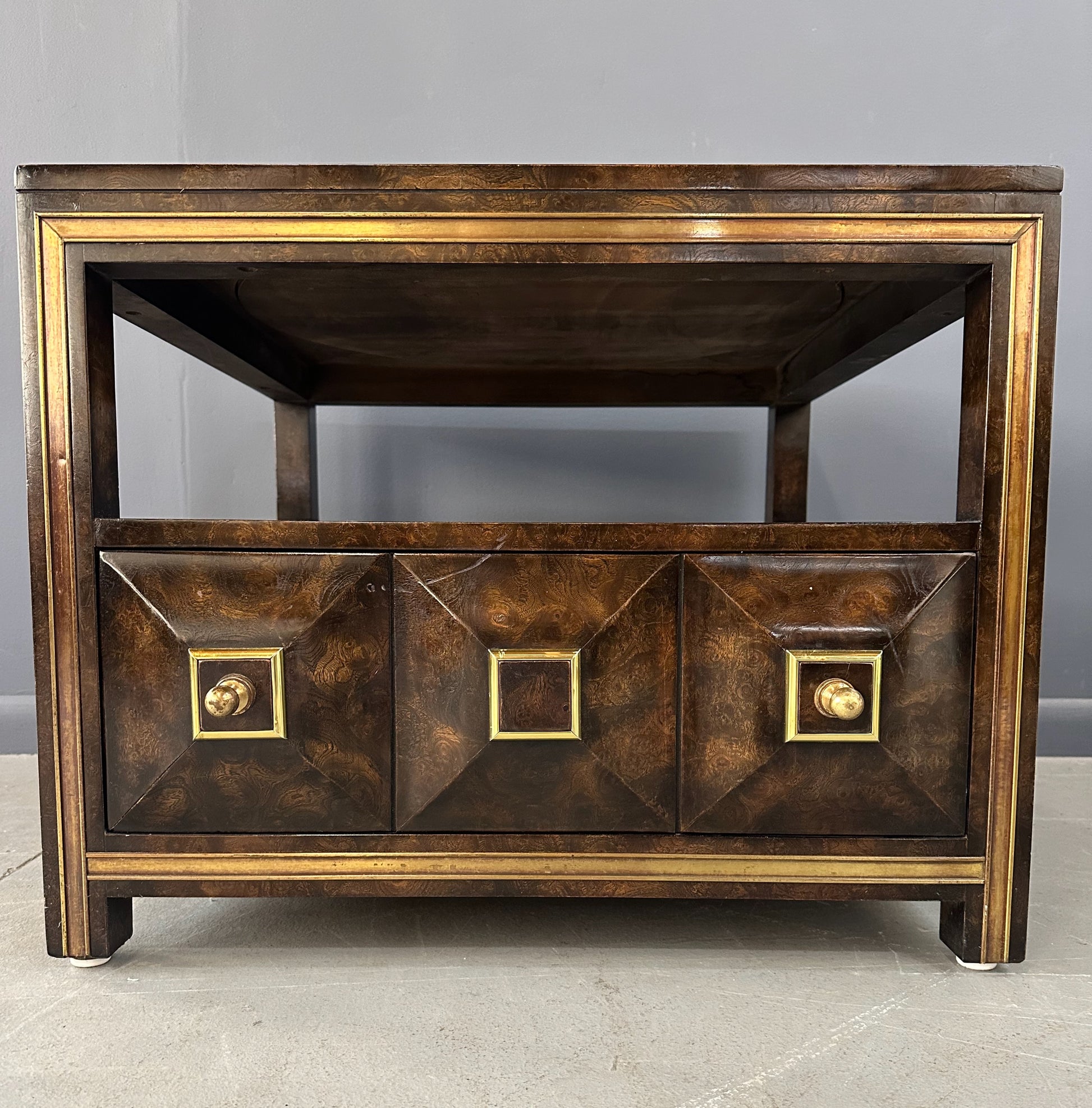 Large Mastercraft end table or nightstand featuring rich burl elm wood, brass trim, open shelving, and a drawer with geometric brass pulls