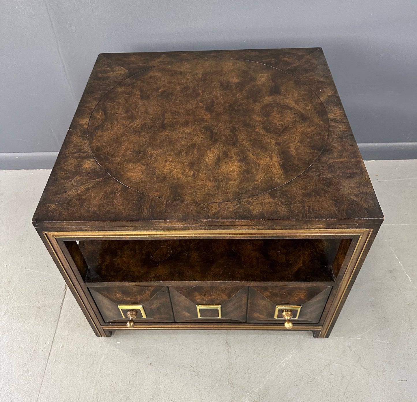 Large Mastercraft end table or nightstand featuring rich burl elm wood, brass trim, open shelving, and a drawer with geometric brass pulls