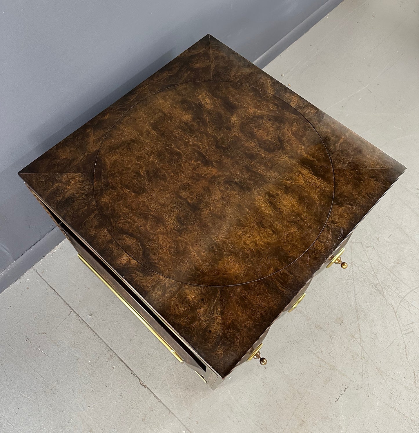 Large Mastercraft end table or nightstand featuring rich burl elm wood, brass trim, open shelving, and a drawer with geometric brass pulls