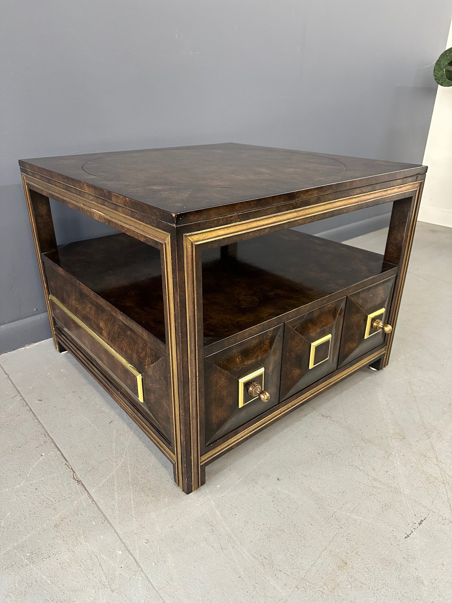 Large Mastercraft end table or nightstand featuring rich burl elm wood, brass trim, open shelving, and a drawer with geometric brass pulls
