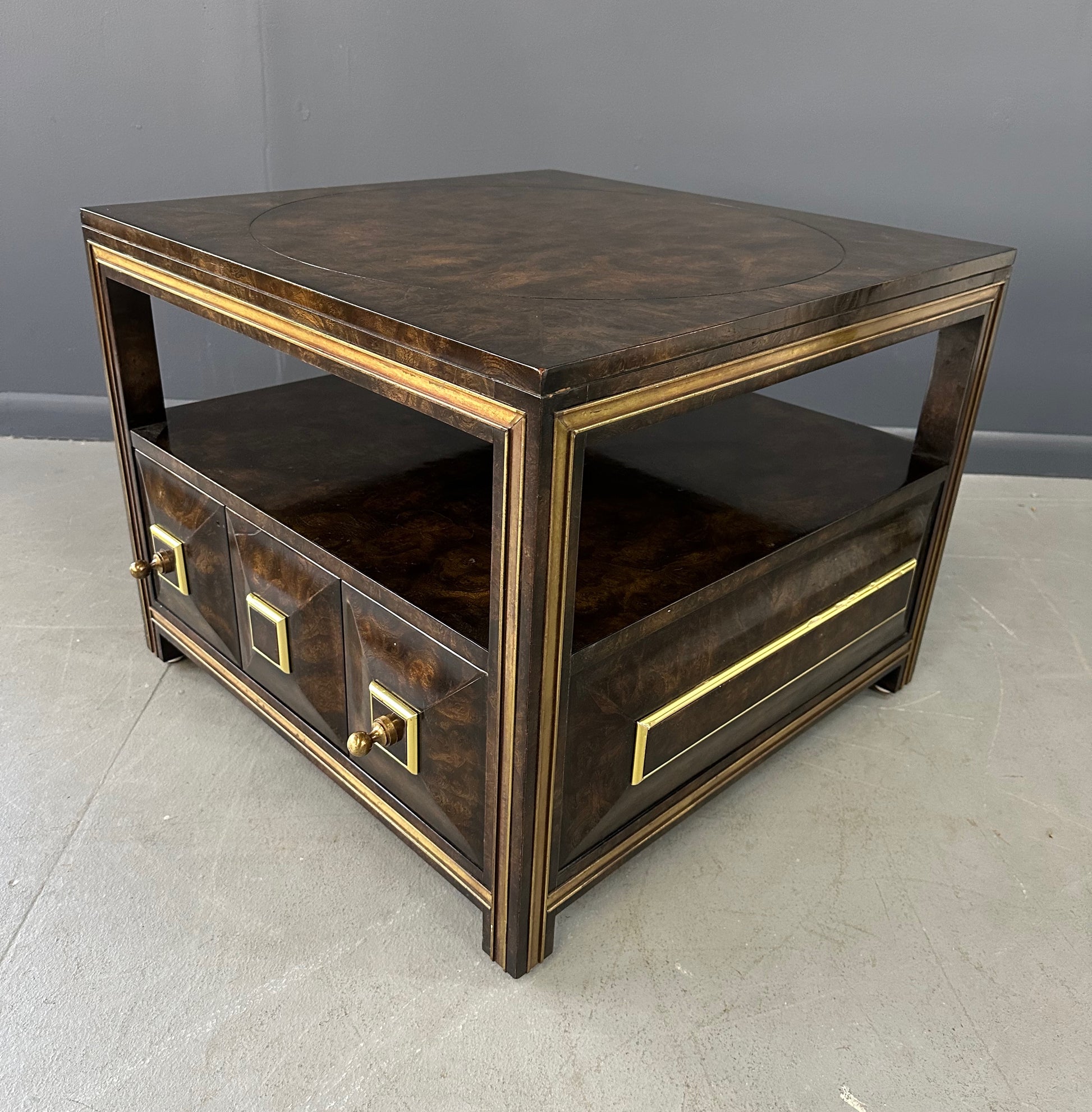 Large Mastercraft end table or nightstand featuring rich burl elm wood, brass trim, open shelving, and a drawer with geometric brass pulls