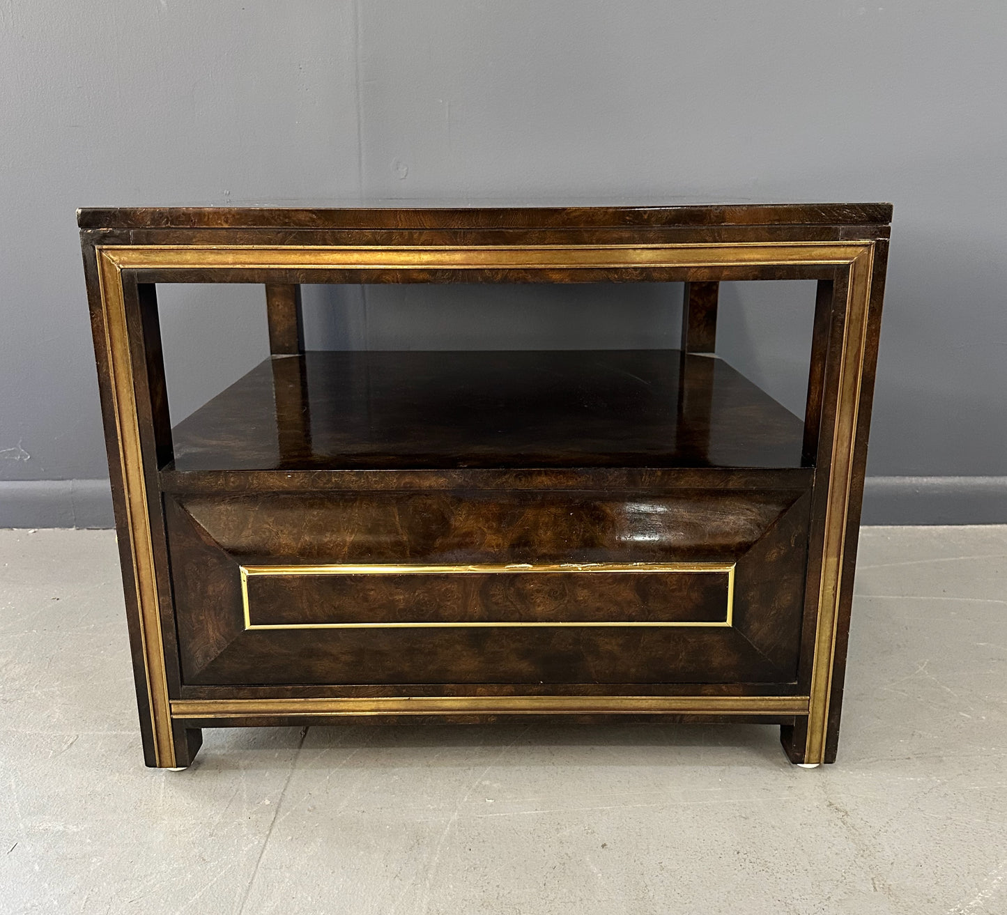 Large Mastercraft end table or nightstand featuring rich burl elm wood, brass trim, open shelving, and a drawer with geometric brass pulls