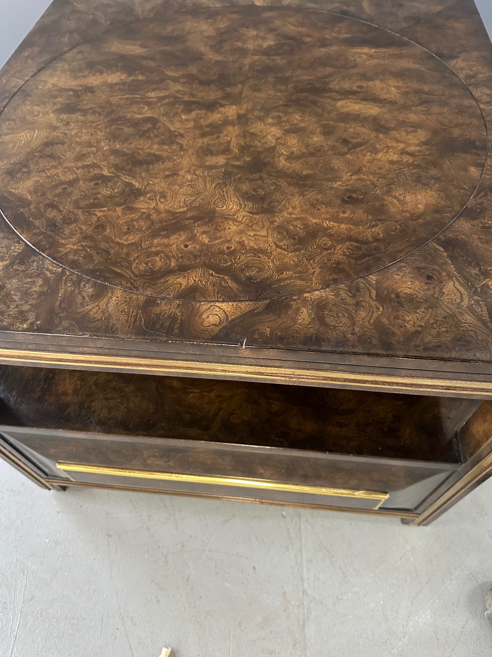 Large Mastercraft end table or nightstand featuring rich burl elm wood, brass trim, open shelving, and a drawer with geometric brass pulls