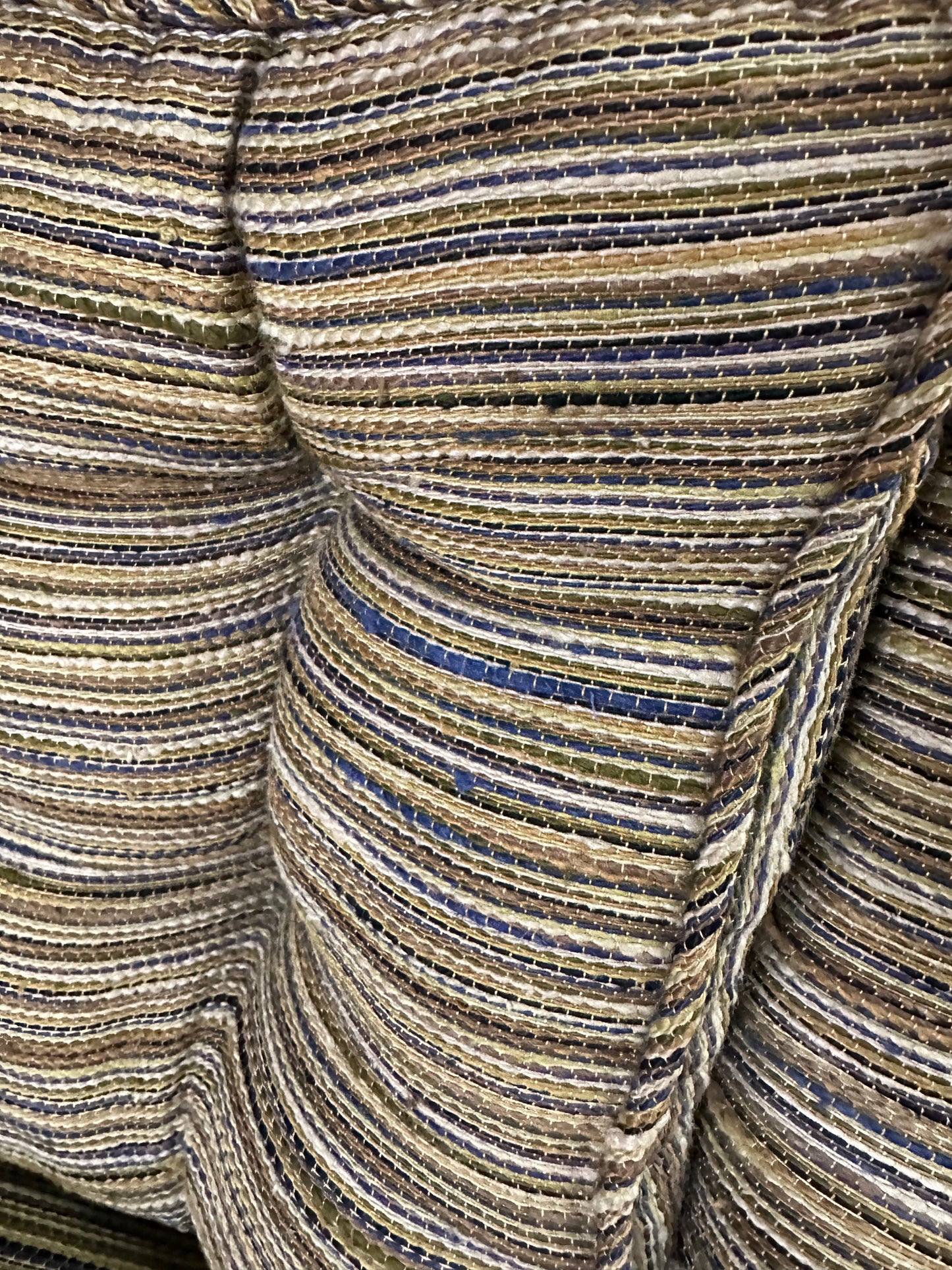 Pair of mid-century lounge chairs with tapered walnut legs, upholstered in original striped multicolor fabric with tufted backs and plush cushions