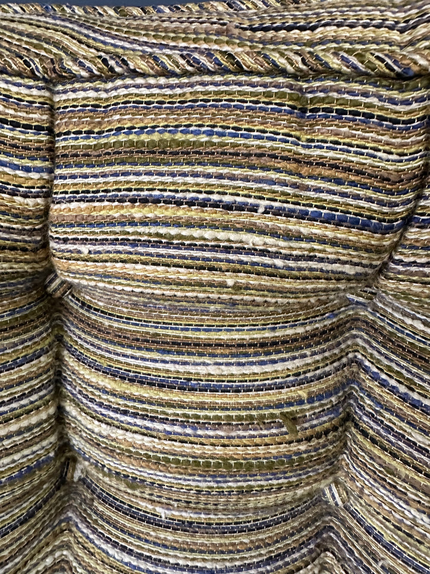 Pair of mid-century lounge chairs with tapered walnut legs, upholstered in original striped multicolor fabric with tufted backs and plush cushions