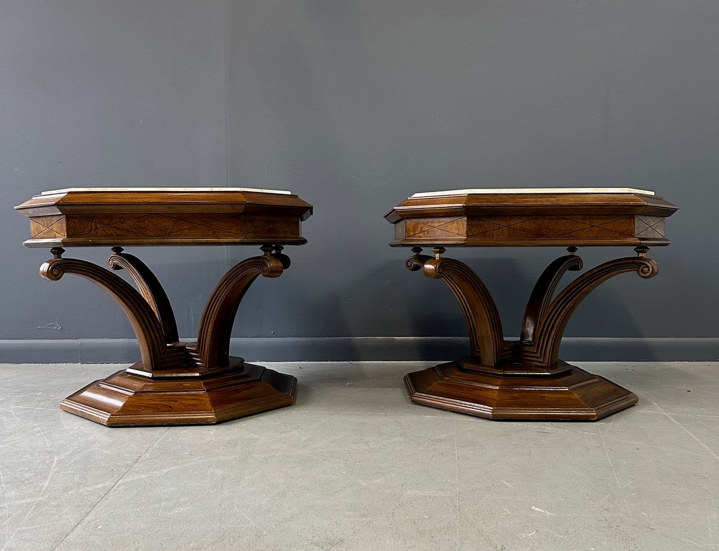 Pair of Hollywood Regency octagonal side tables featuring sculpted wooden bases and creamy Calacatta marble tops with elegant veining.