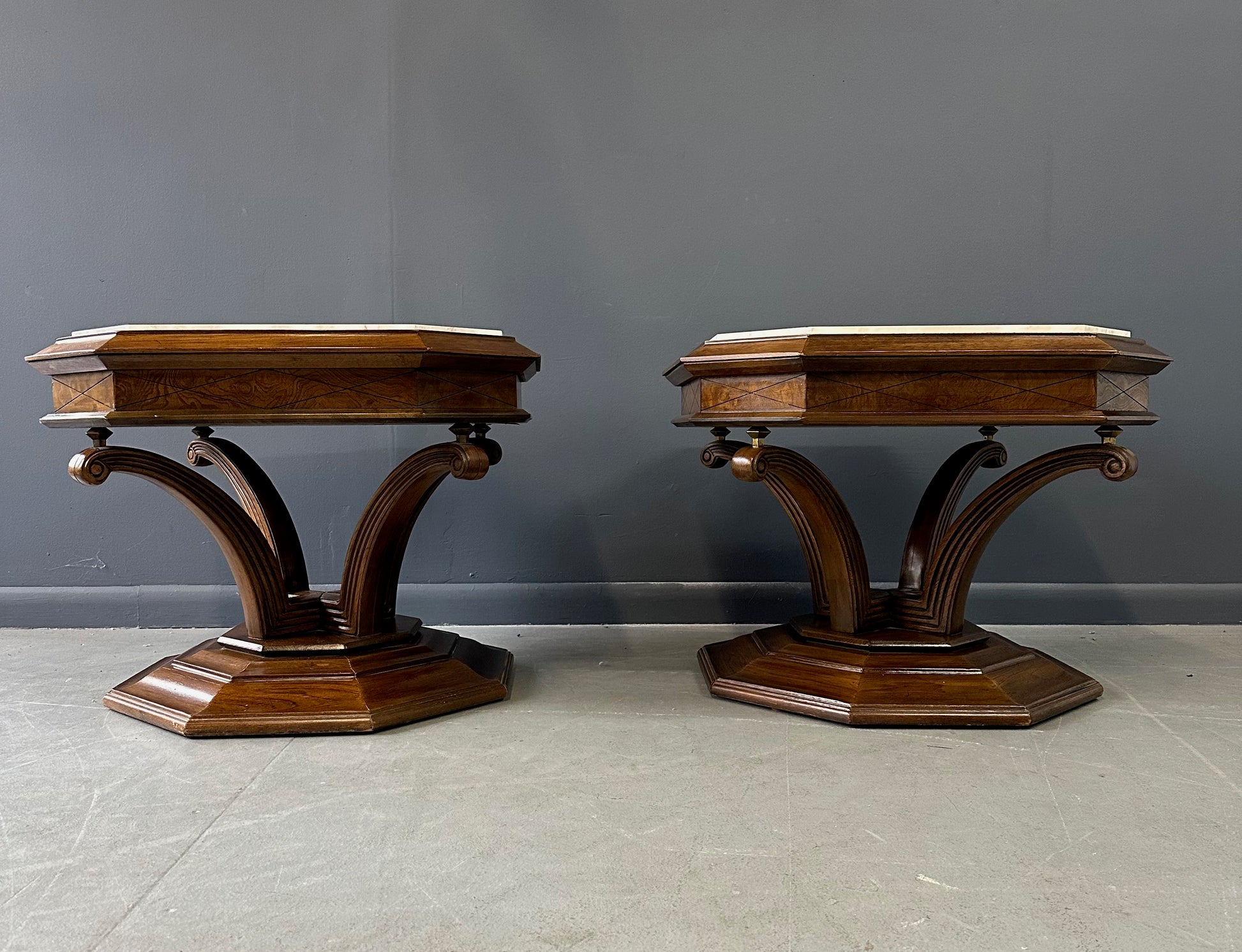 Pair of Hollywood Regency octagonal side tables featuring sculpted wooden bases and creamy Calacatta marble tops with elegant veining.