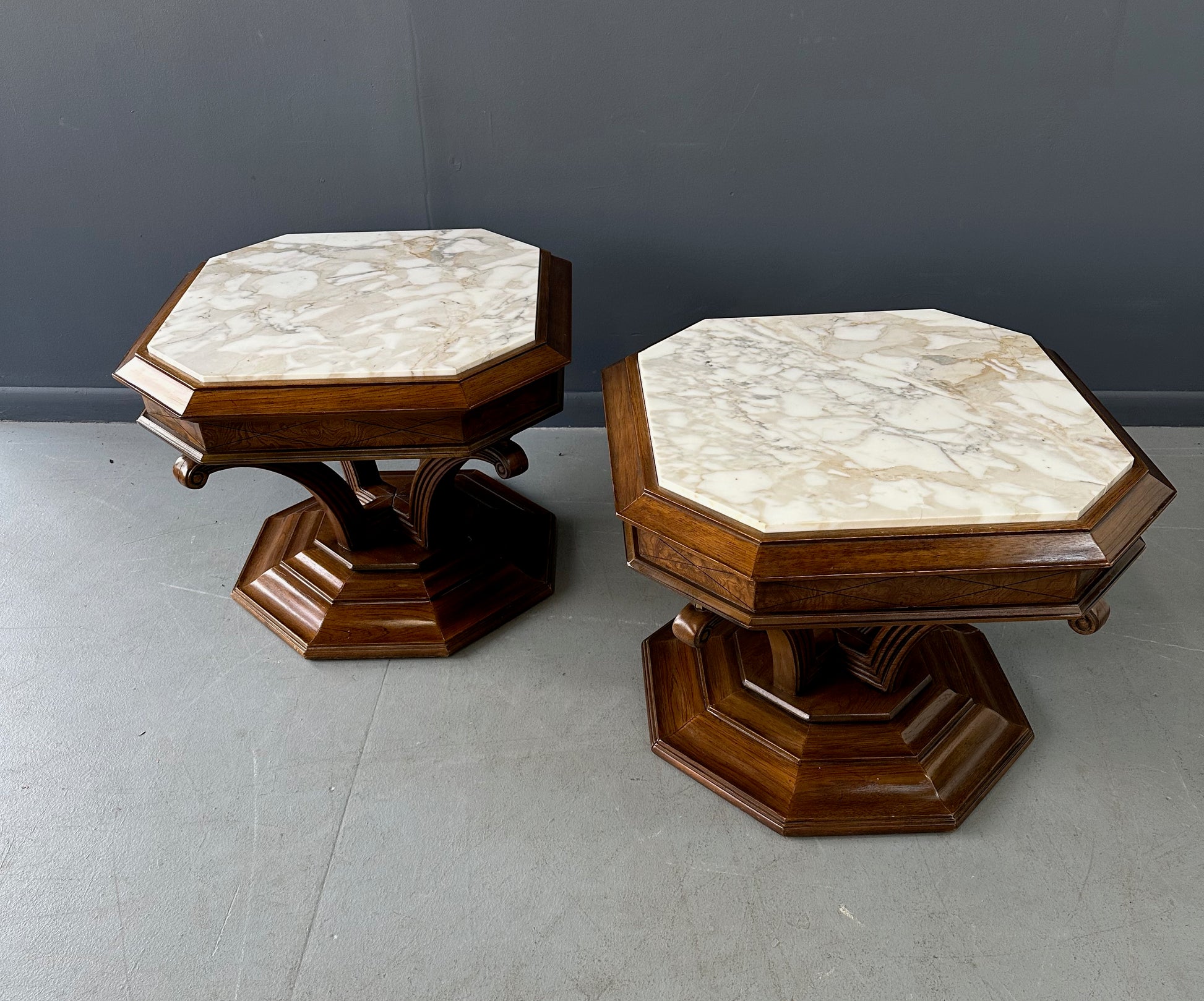 Pair of Hollywood Regency octagonal side tables featuring sculpted wooden bases and creamy Calacatta marble tops with elegant veining.