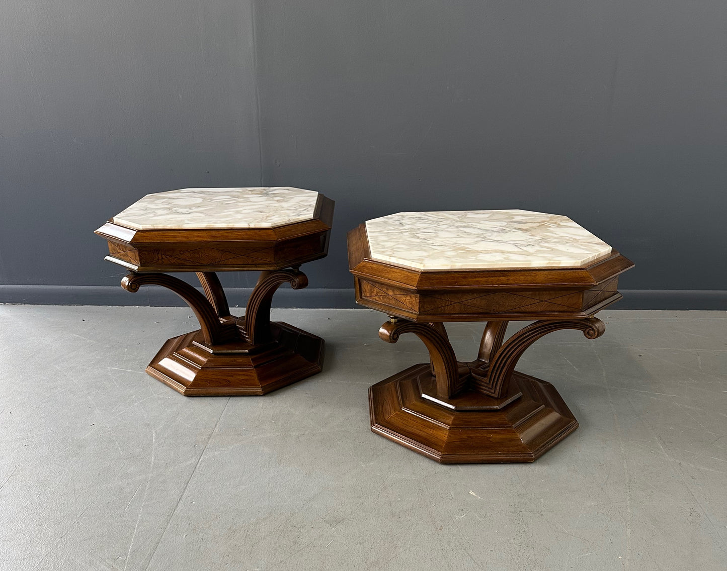 Pair of Hollywood Regency octagonal side tables featuring sculpted wooden bases and creamy Calacatta marble tops with elegant veining.