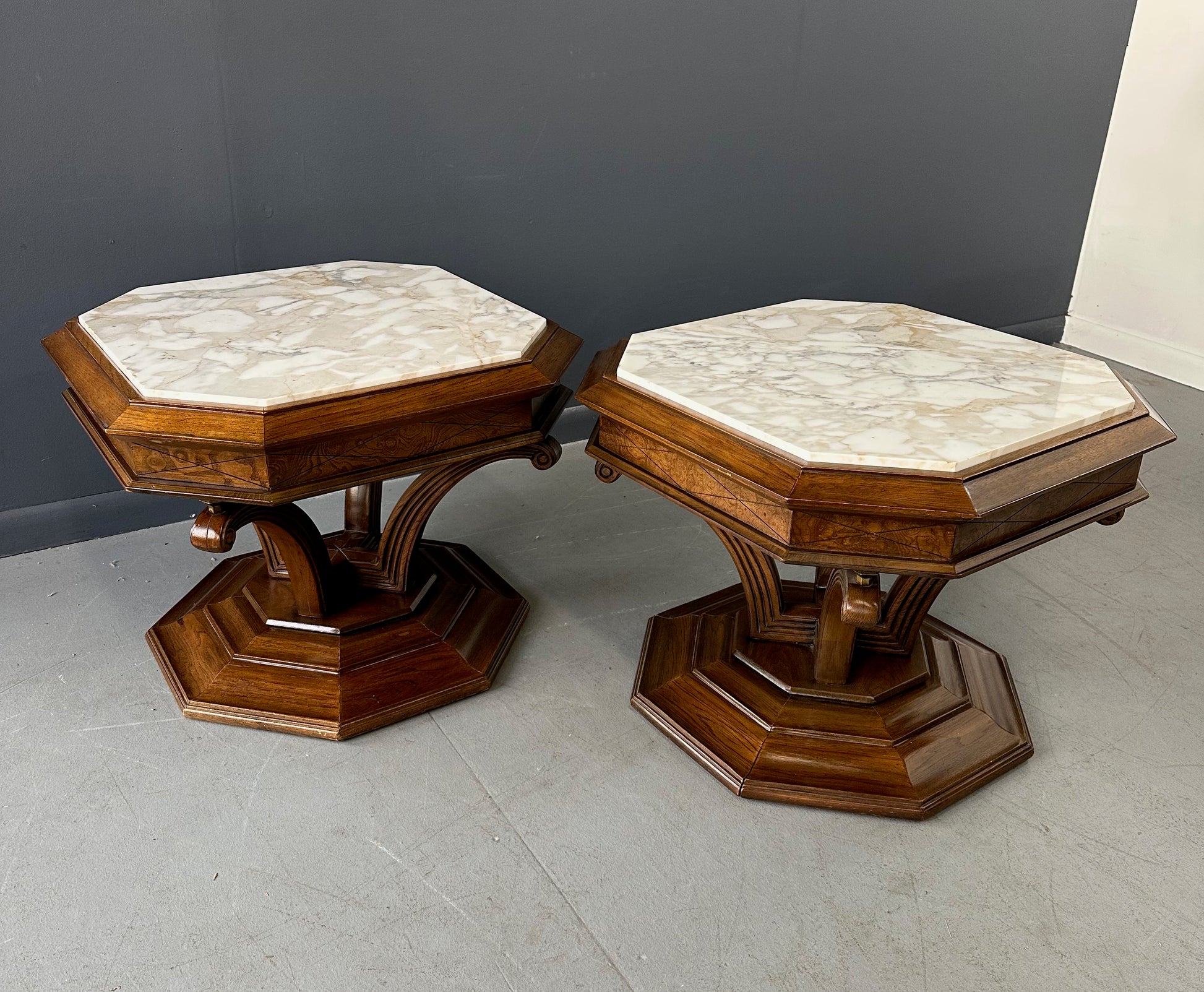 Pair of Hollywood Regency octagonal side tables featuring sculpted wooden bases and creamy Calacatta marble tops with elegant veining.