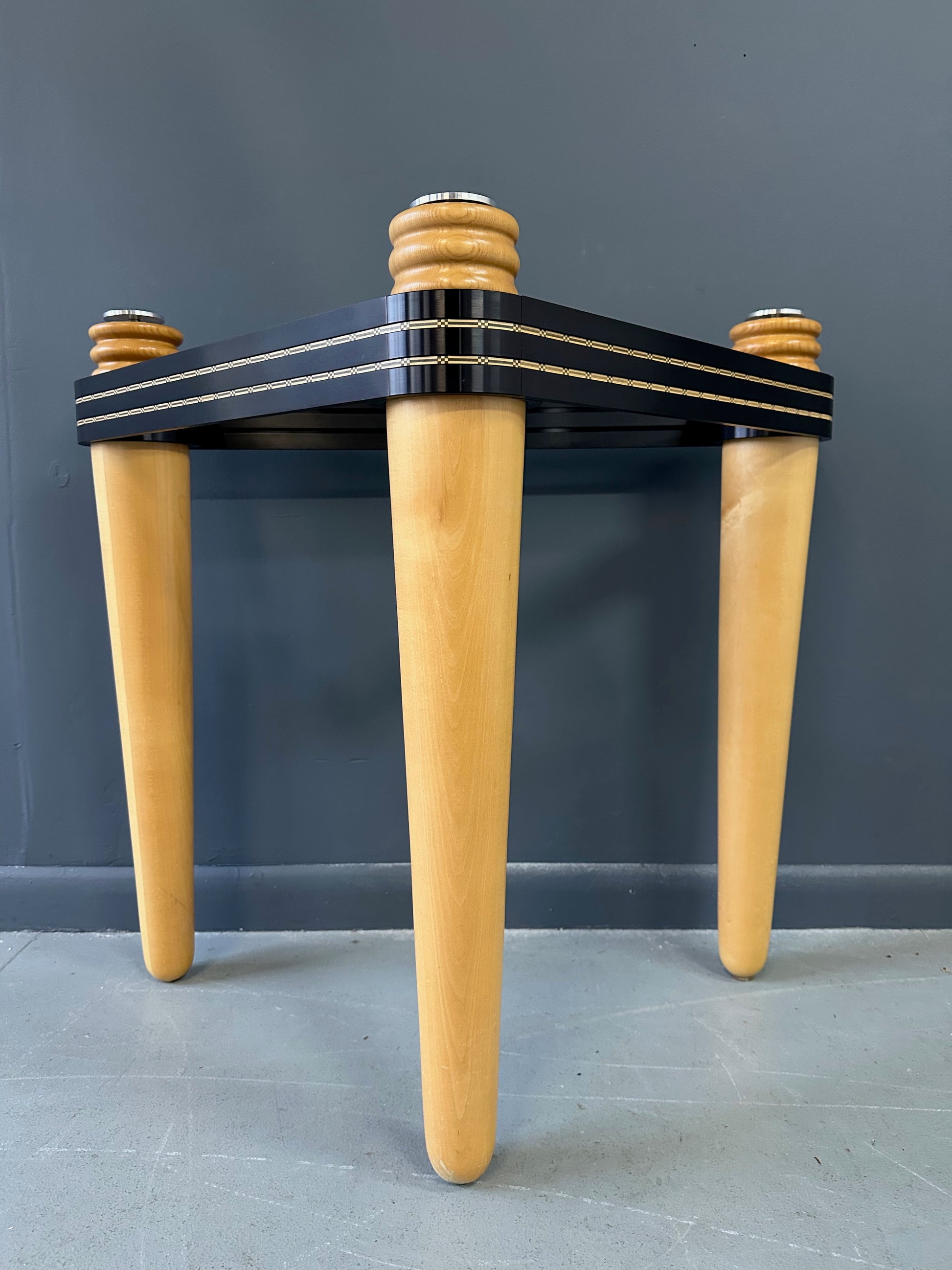 1990 demi-lune hall table designed by Kaiser Newman, featuring a curved green glass top, light beech wood legs, and a black lacquered frame with white inlay detailing