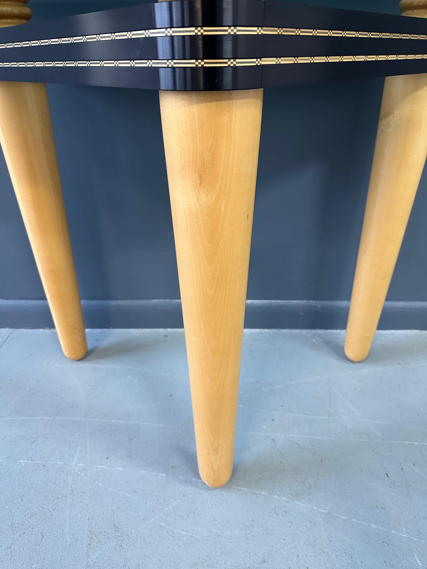 1990 demi-lune hall table designed by Kaiser Newman, featuring a curved green glass top, light beech wood legs, and a black lacquered frame with white inlay detailing