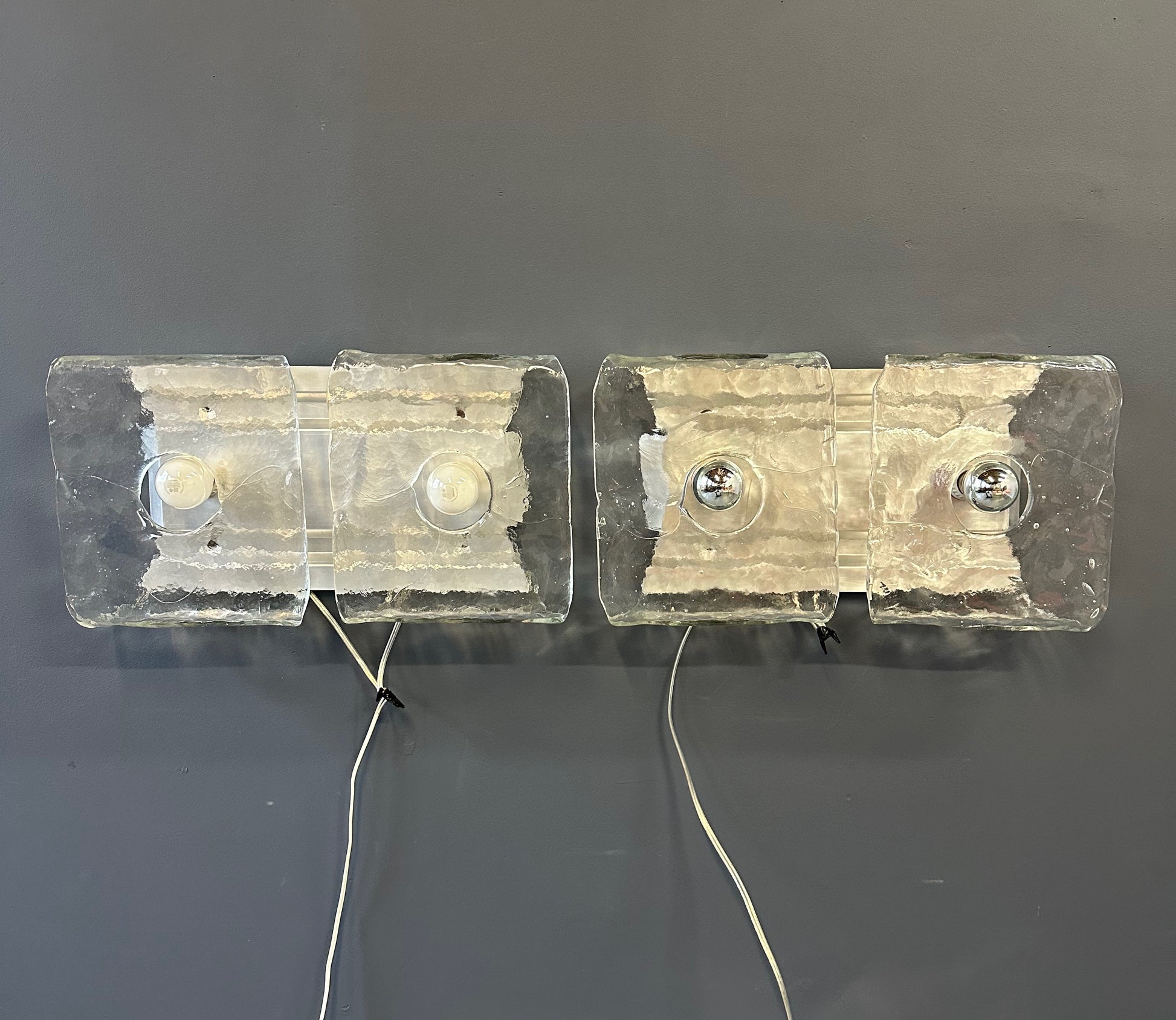 Set of two vintage 1960s Carlo Nason for Kalmar Franken glass wall lights featuring textured square glass shades mounted on a horizontal metal fixture
