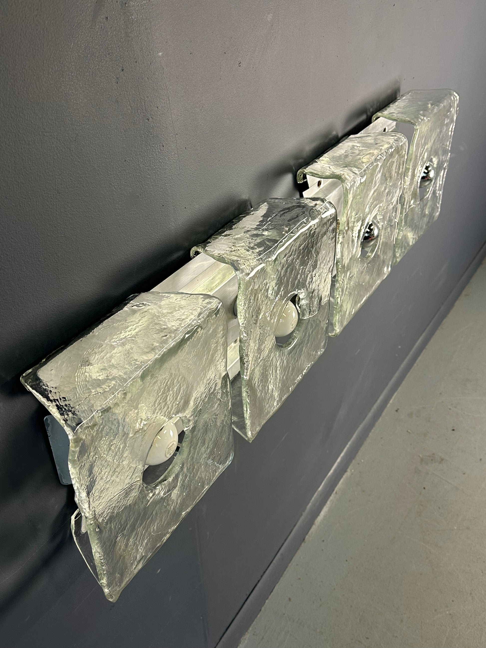Set of two vintage 1960s Carlo Nason for Kalmar Franken glass wall lights featuring textured square glass shades mounted on a horizontal metal fixture