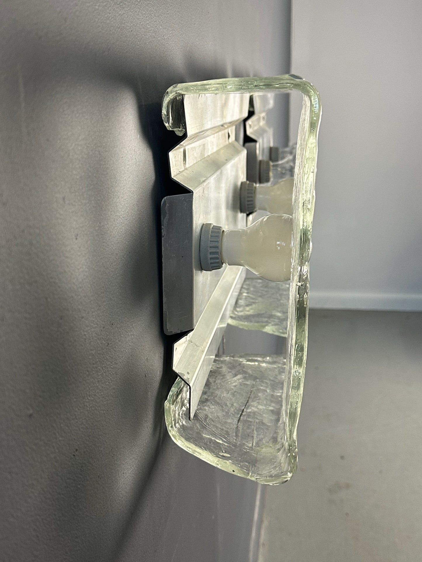 Set of two vintage 1960s Carlo Nason for Kalmar Franken glass wall lights featuring textured square glass shades mounted on a horizontal metal fixture