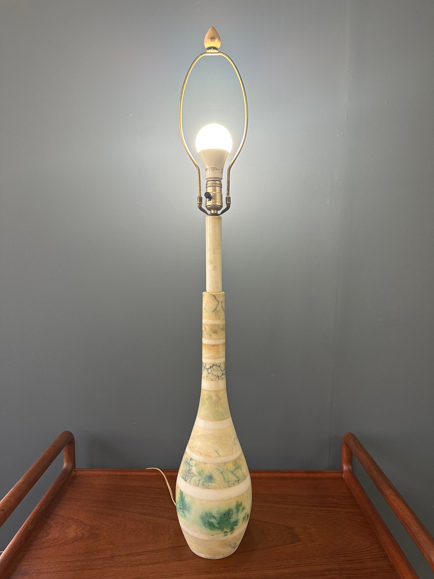 Mid-century Italian tall table lamp featuring a stacked marble design in blue, green, and beige tones, with a slender neck 