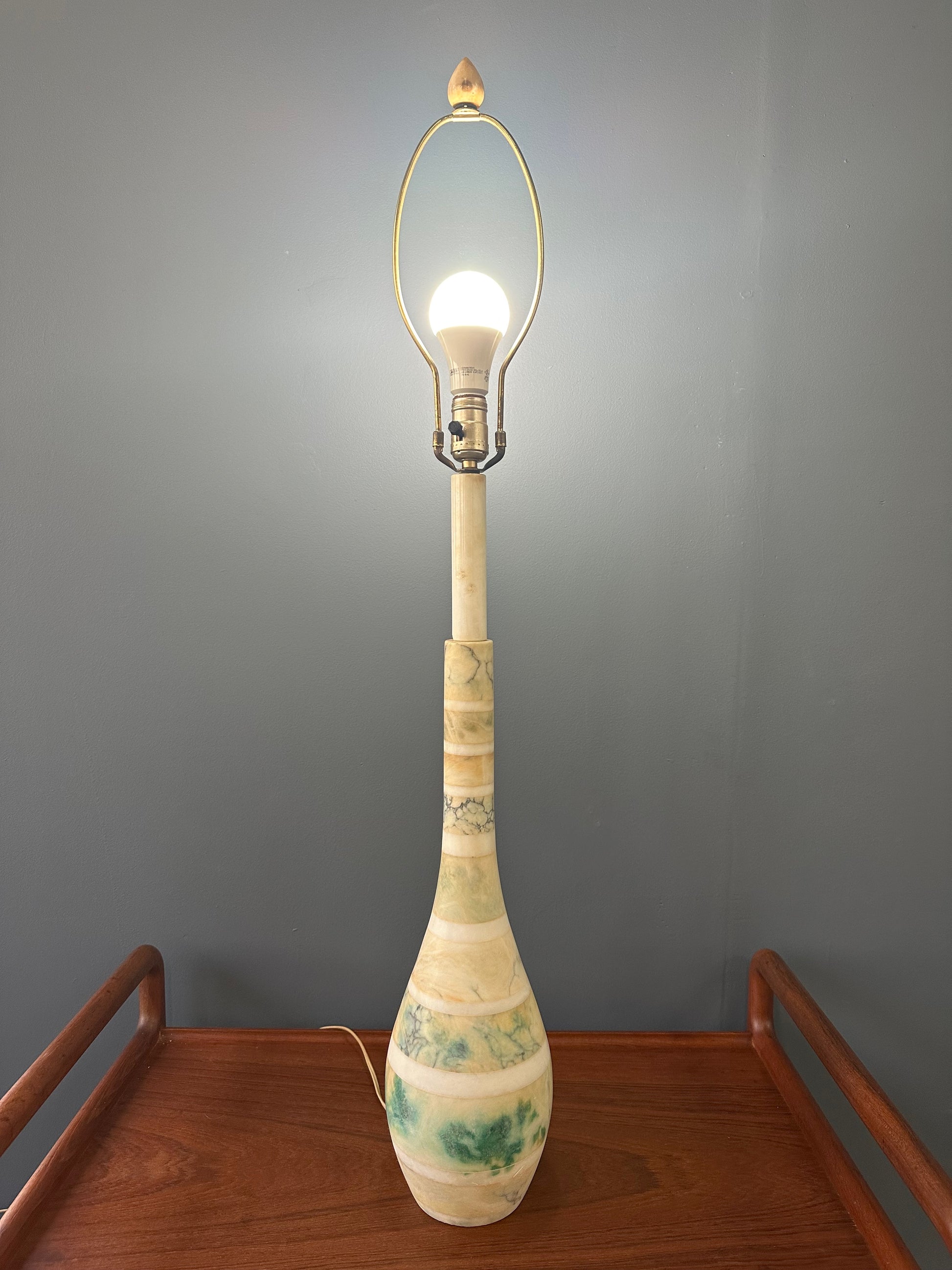 Mid-century Italian tall table lamp featuring a stacked marble design in blue, green, and beige tones, with a slender neck 