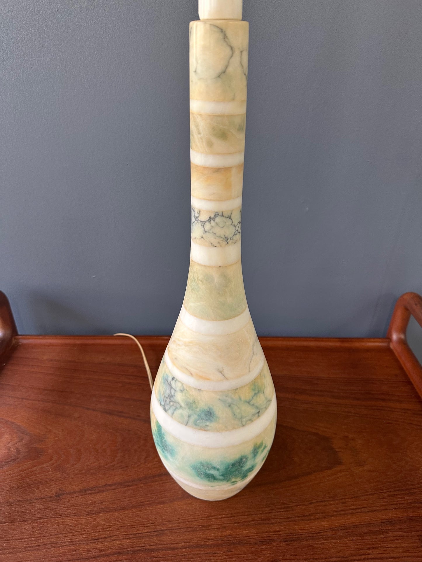 Mid-century Italian tall table lamp featuring a stacked marble design in blue, green, and beige tones, with a slender neck 