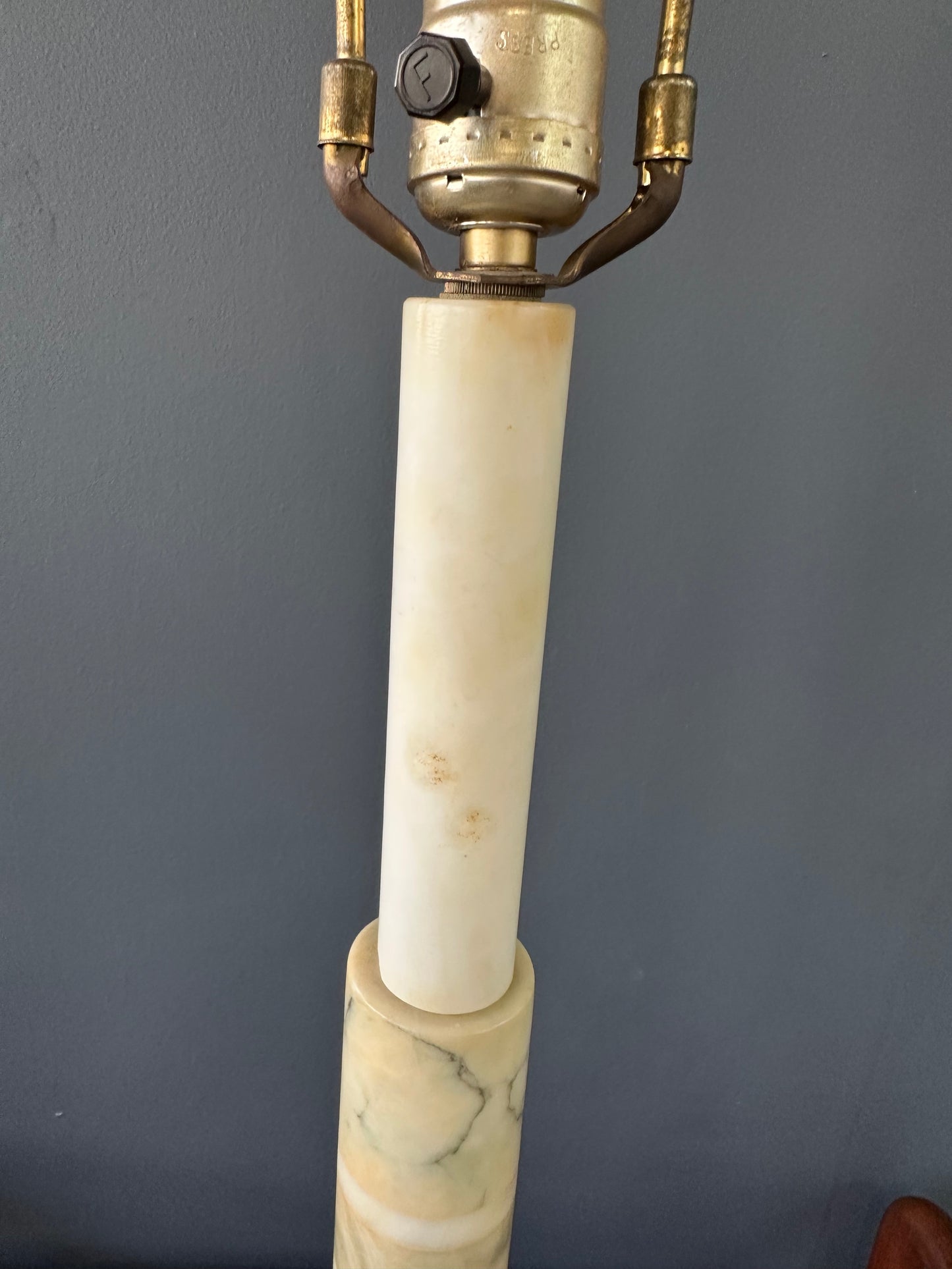 Mid-century Italian tall table lamp featuring a stacked marble design in blue, green, and beige tones, with a slender neck 