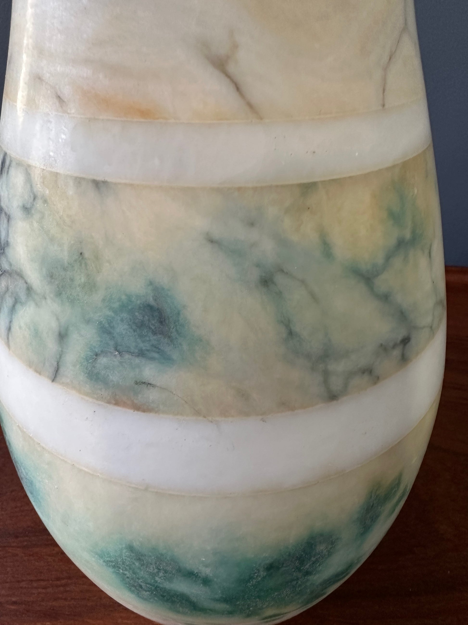 Mid-century Italian tall table lamp featuring a stacked marble design in blue, green, and beige tones, with a slender neck 