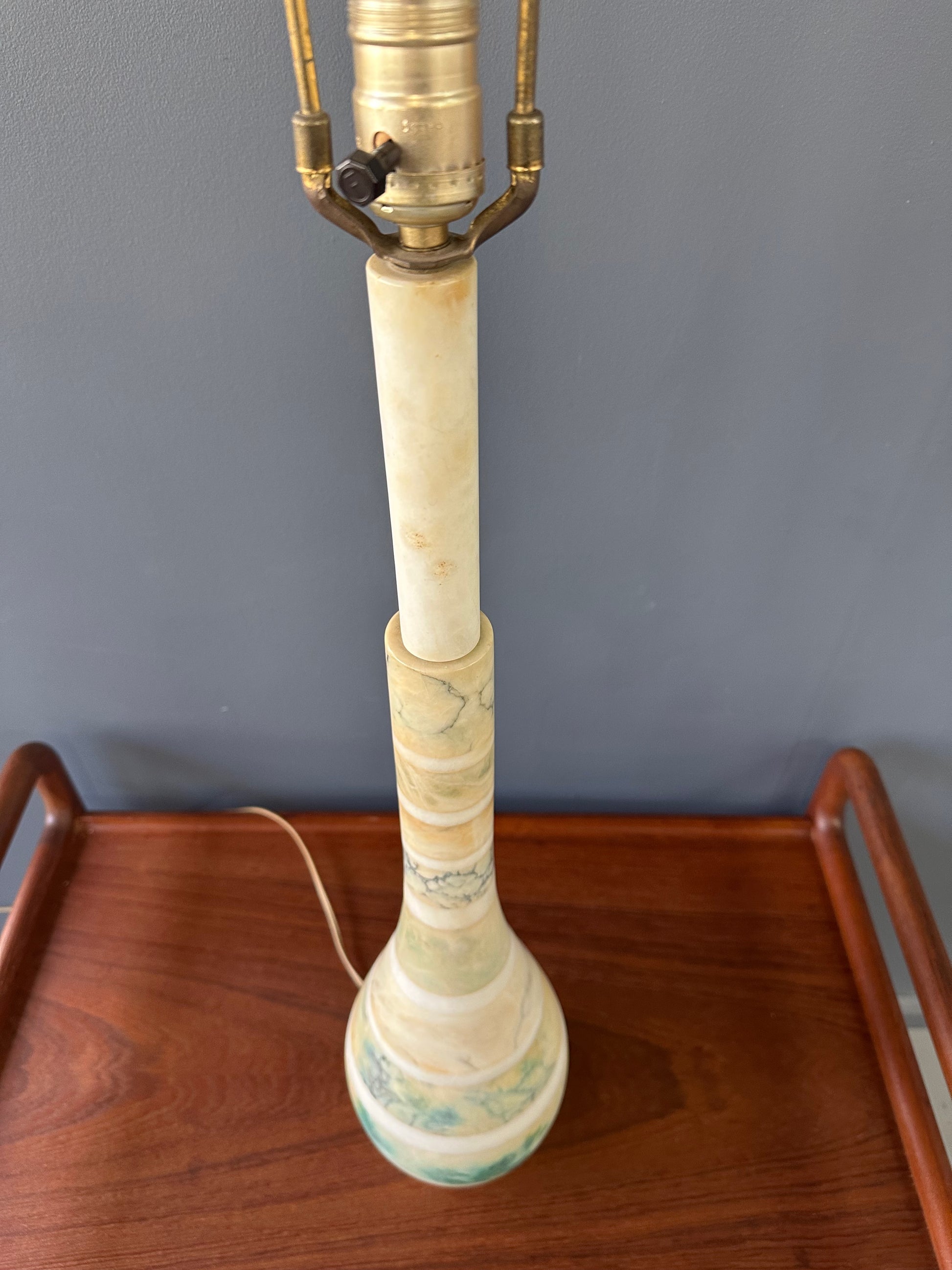 Mid-century Italian tall table lamp featuring a stacked marble design in blue, green, and beige tones, with a slender neck 