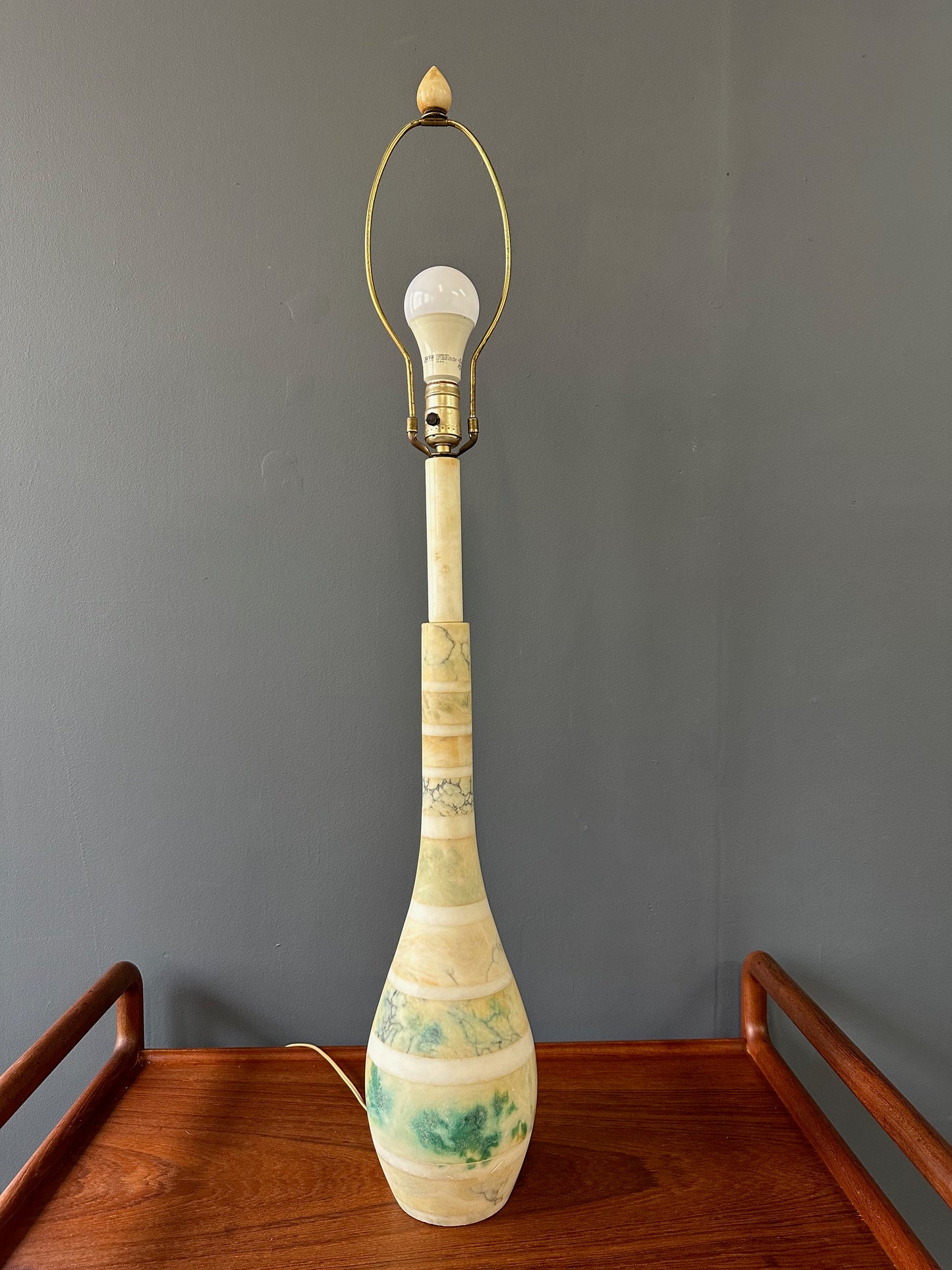 Mid-century Italian tall table lamp featuring a stacked marble design in blue, green, and beige tones, with a slender neck 