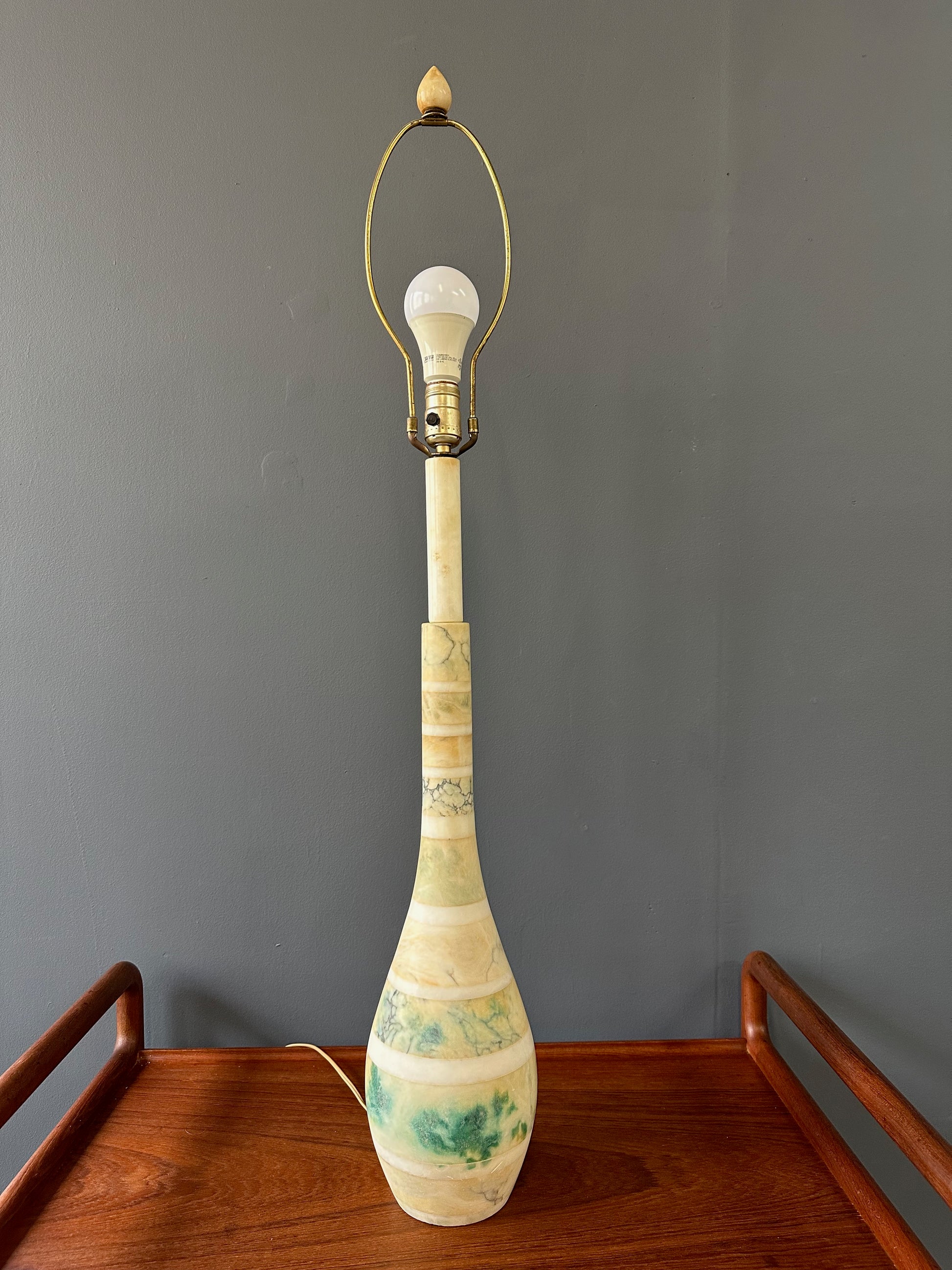 Mid-century Italian tall table lamp featuring a stacked marble design in blue, green, and beige tones, with a slender neck 