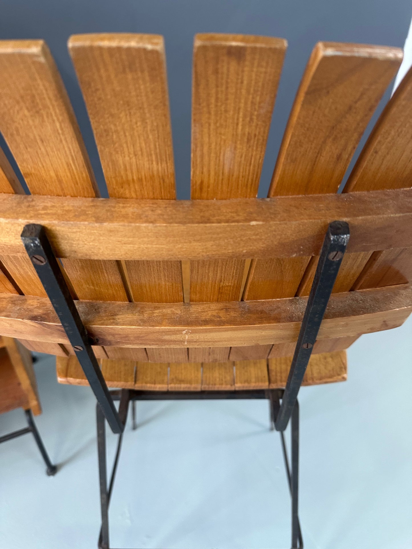 Mid-Century Modern dry bar console with matching stool by Arthur Umanoff, 1950s, featuring slatted wood panels, iron legs, and a curved wooden seat and backrest with minimalist black metal framing