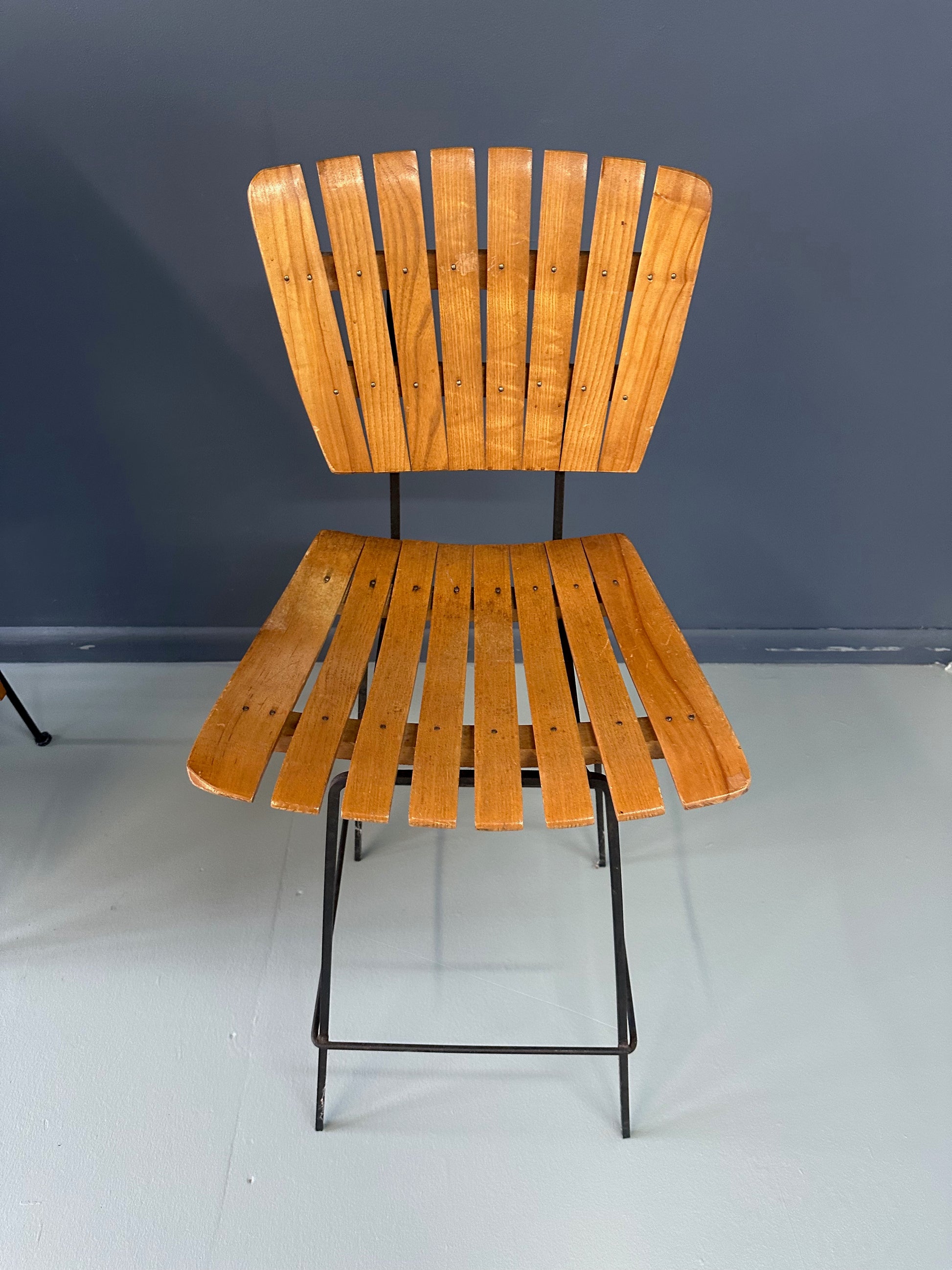 Mid-Century Modern dry bar console with matching stool by Arthur Umanoff, 1950s, featuring slatted wood panels, iron legs, and a curved wooden seat and backrest with minimalist black metal framing