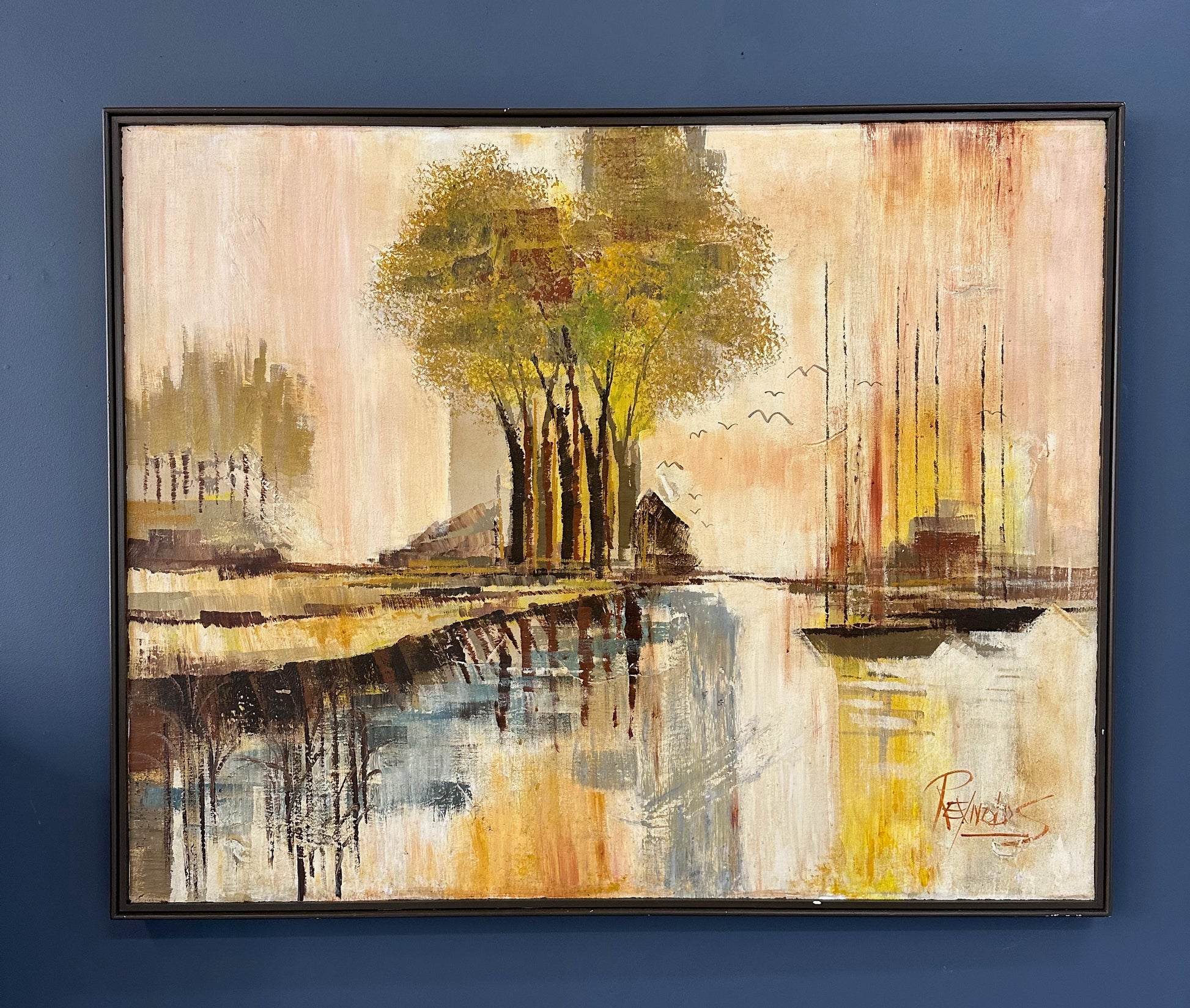 1970s landscape painting by Lee Reynolds featuring abstractly rendered trees, boats with tall masts, water reflections, and distant buildings in warm tones of yellow, orange, and brown