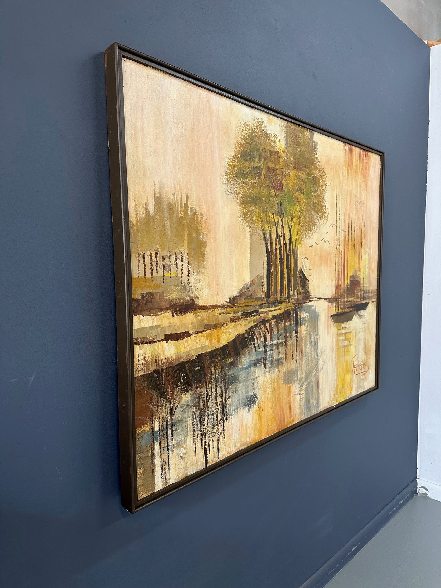 1970s landscape painting by Lee Reynolds featuring abstractly rendered trees, boats with tall masts, water reflections, and distant buildings in warm tones of yellow, orange, and brown
