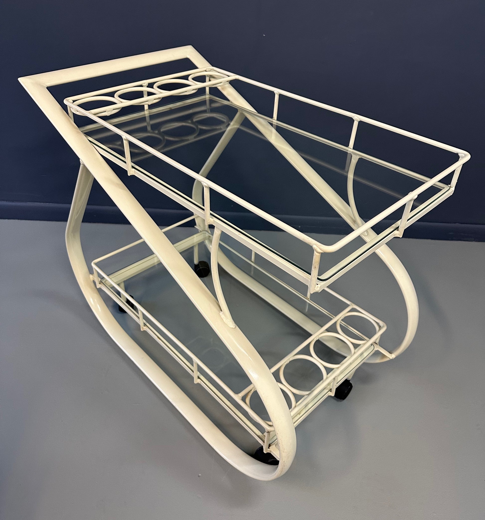 Vintage 1980s postmodern two-tier bar cart with curvy metal frame and glass shelves, attributed to Woodard