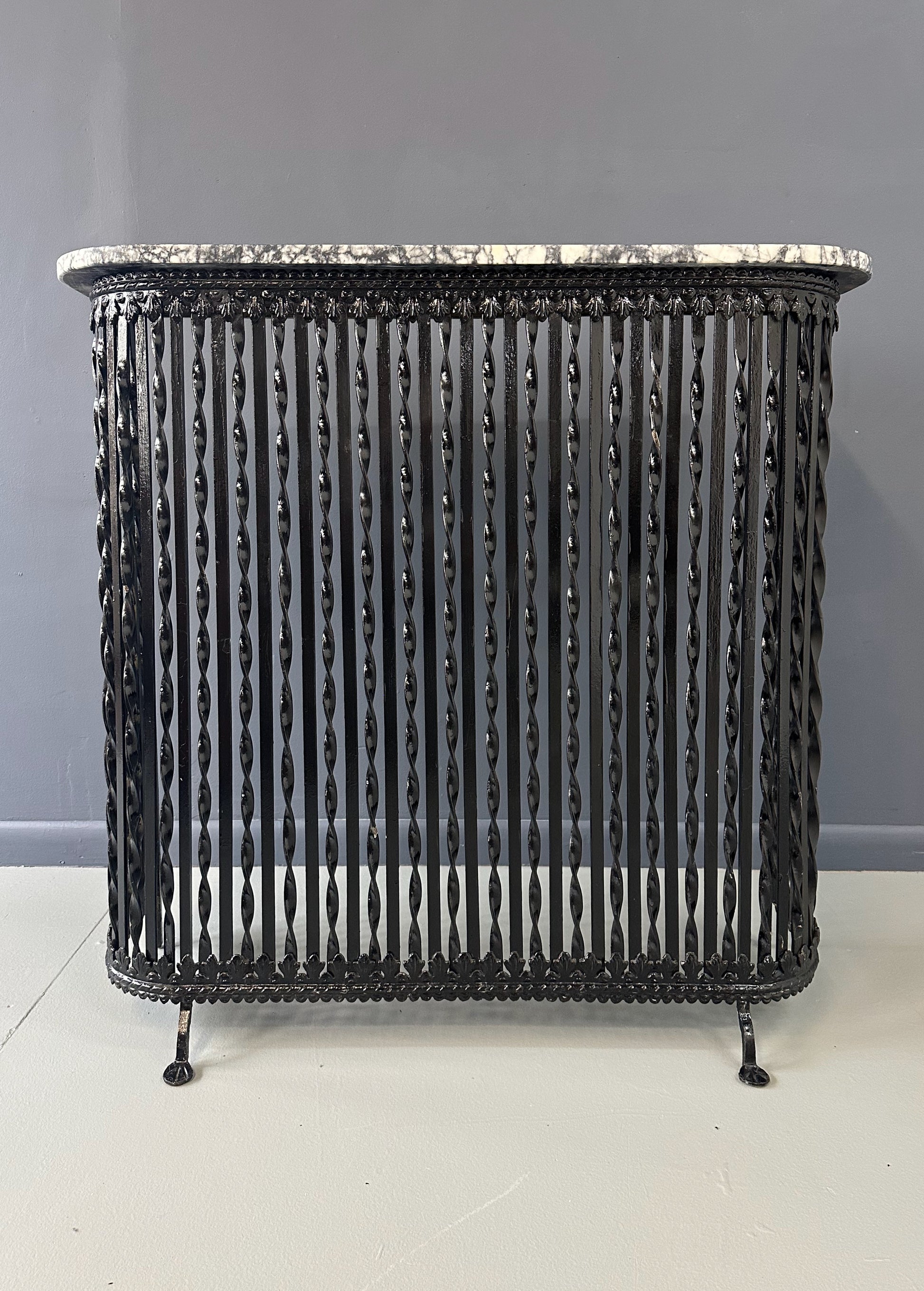 Late 19th-century antique radiator cover with ornate wrought iron design and marble slab top, Victorian style