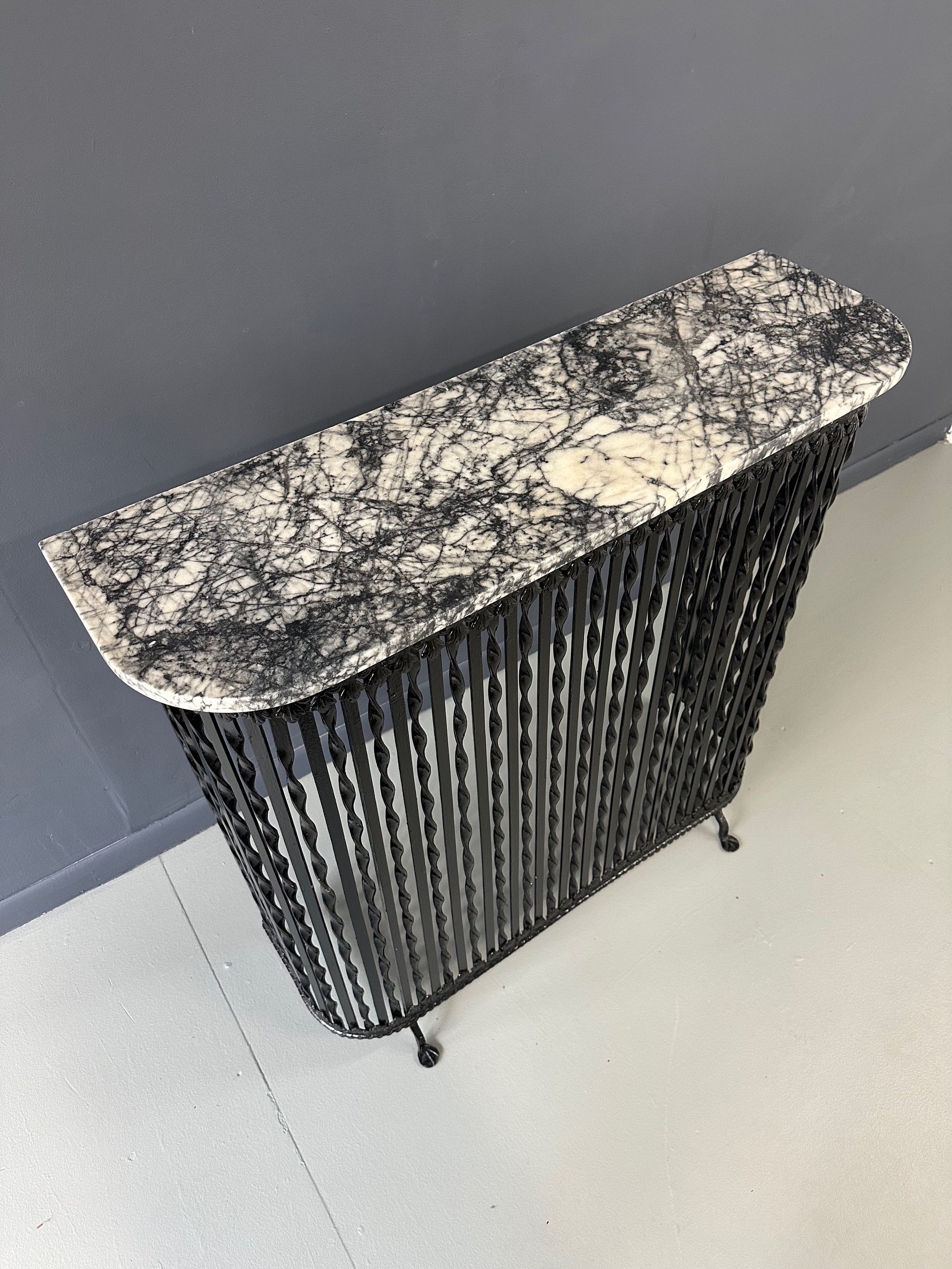 Late 19th-century antique radiator cover with ornate wrought iron design and marble slab top, Victorian style