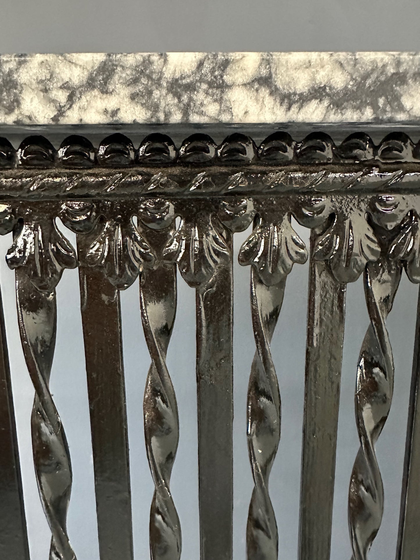 Late 19th-century antique radiator cover with ornate wrought iron design and marble slab top, Victorian style