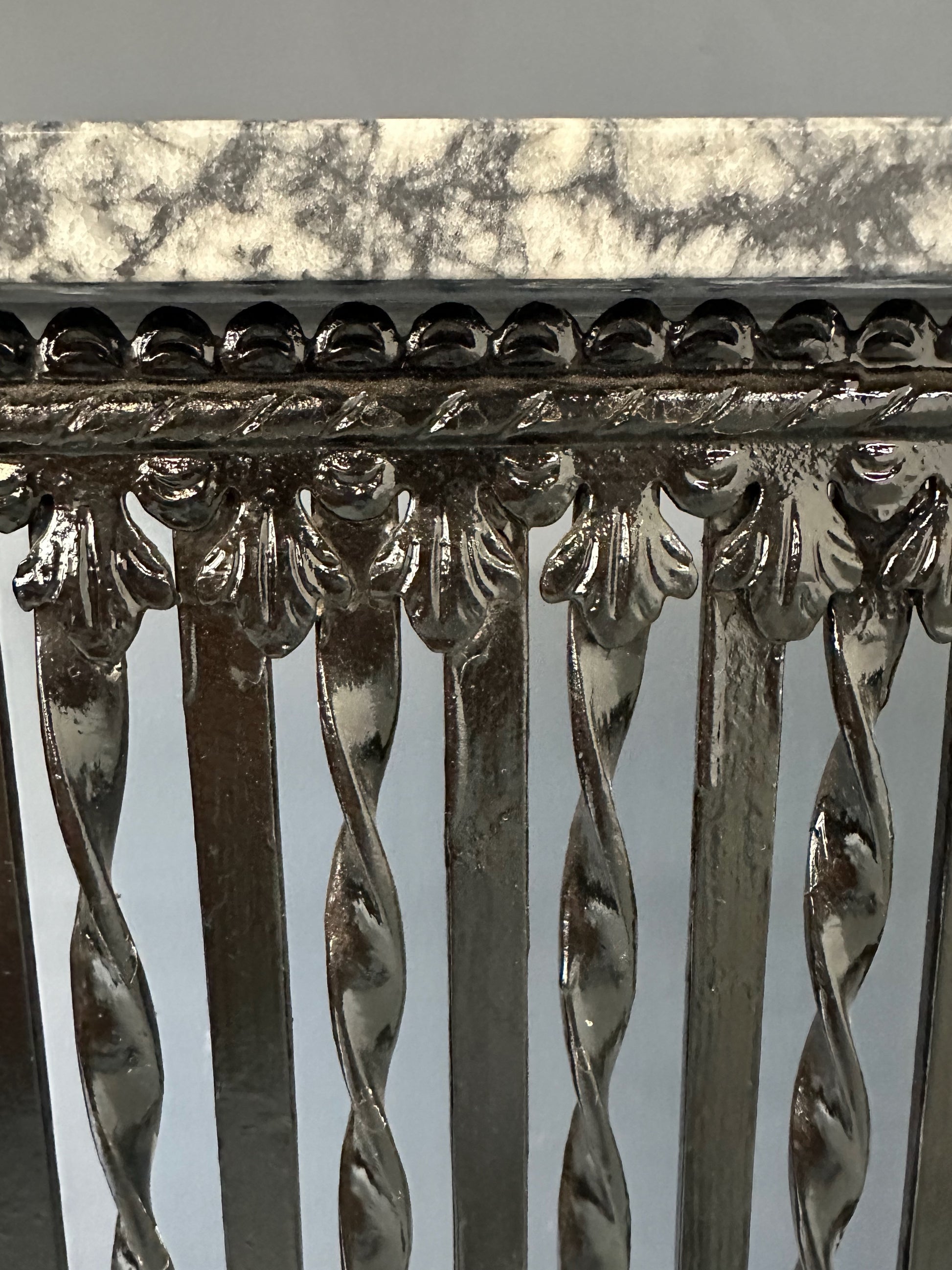 Late 19th-century antique radiator cover with ornate wrought iron design and marble slab top, Victorian style