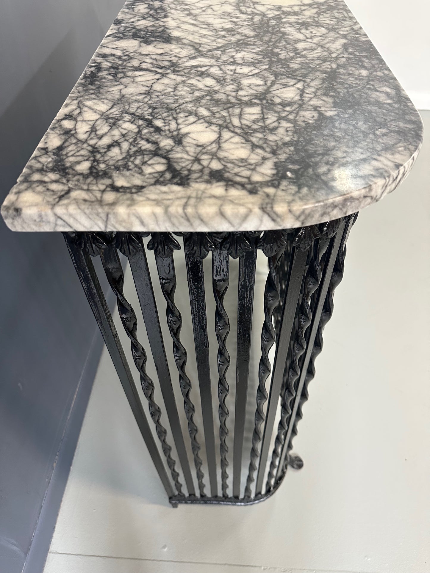Late 19th-century antique radiator cover with ornate wrought iron design and marble slab top, Victorian style