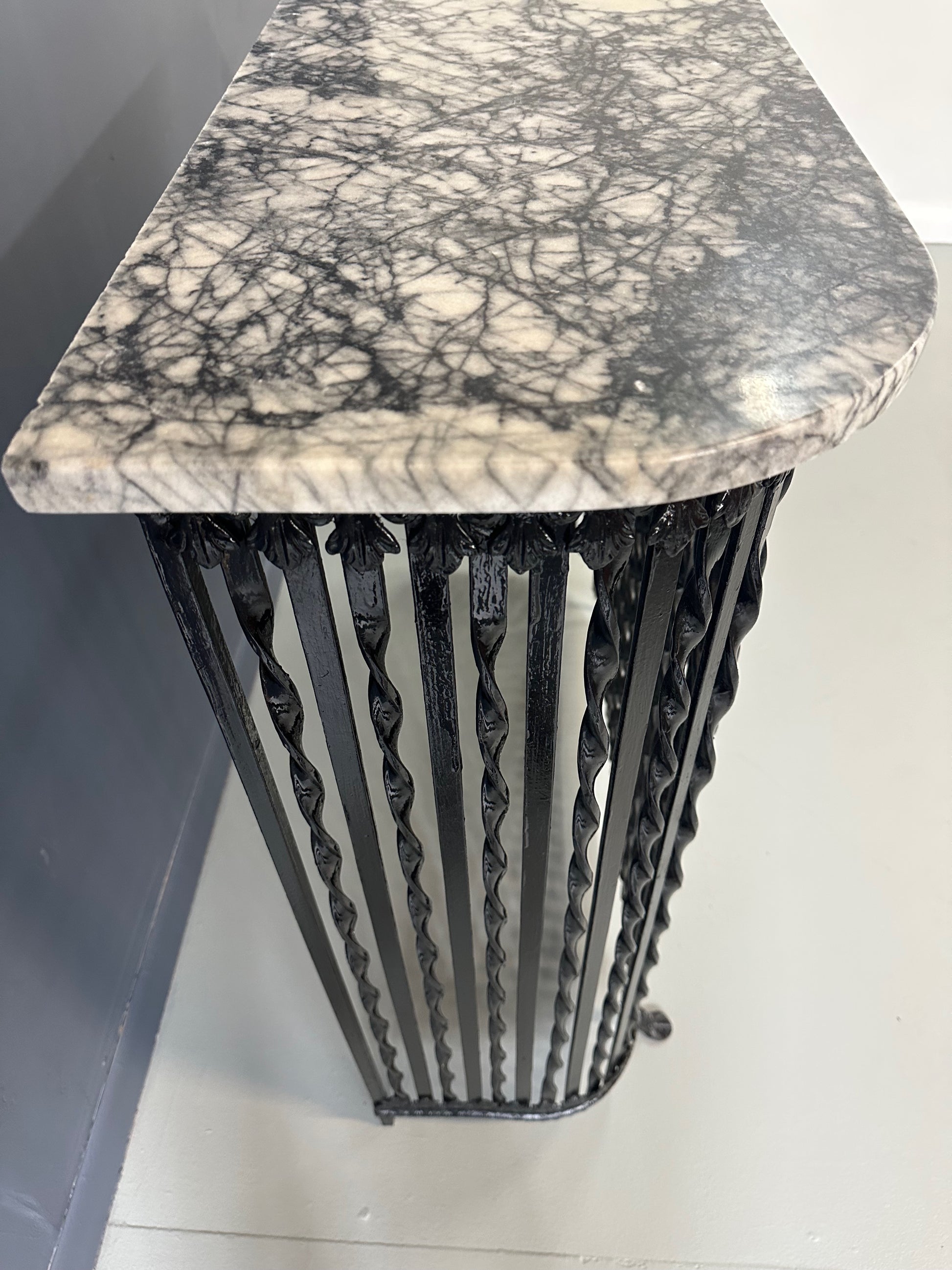 Late 19th-century antique radiator cover with ornate wrought iron design and marble slab top, Victorian style