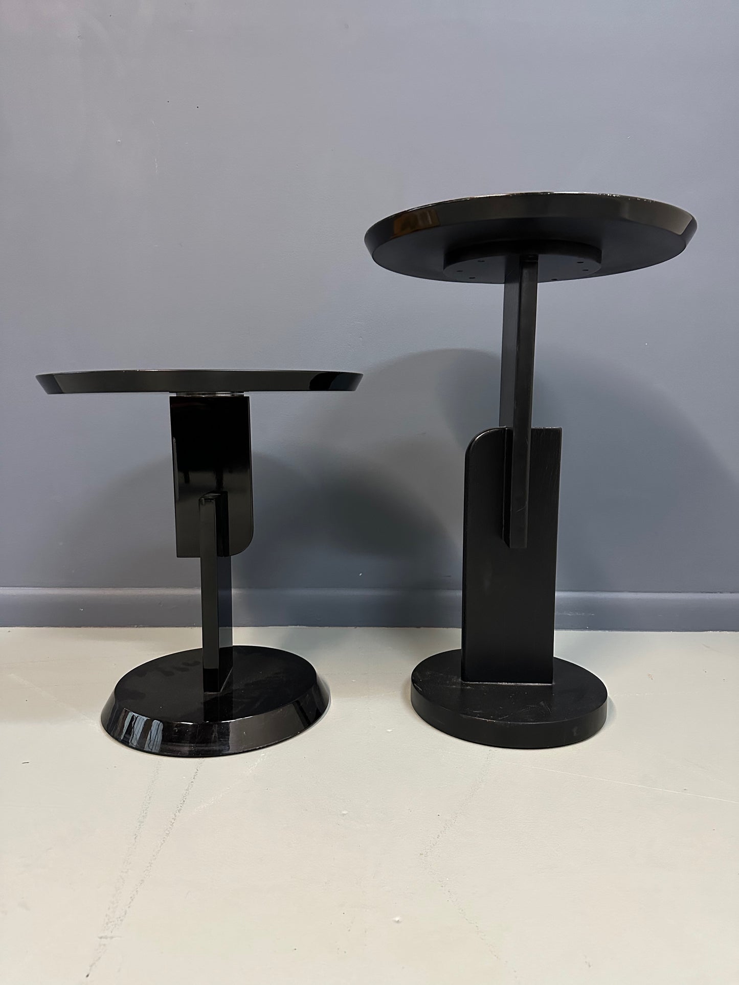 Pair of Carlo Malnati style Postmodern side tables featuring round inlaid wood tops with abstract, multicolored organic patterns and sleek black pedestal bases.
